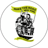 A round button with people holding flags and buildings.